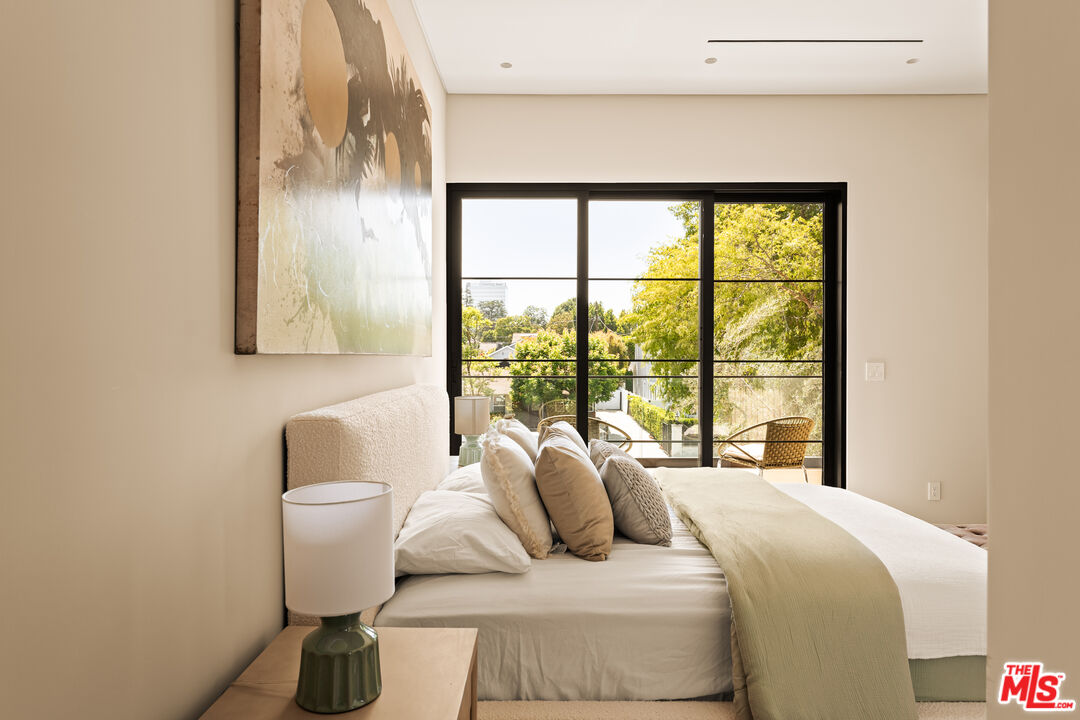 4718 Lemona Avenue Sherman Oaks, CA 91403 - Photo 35 of 40 a bedroom with a bed and a large window