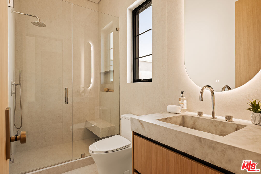4718 Lemona Avenue Sherman Oaks, CA 91403 - Photo 37 of 40 a bathroom with a granite countertop sink a toilet and shower