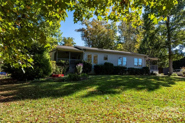 a front view of a house with a yard and porch
