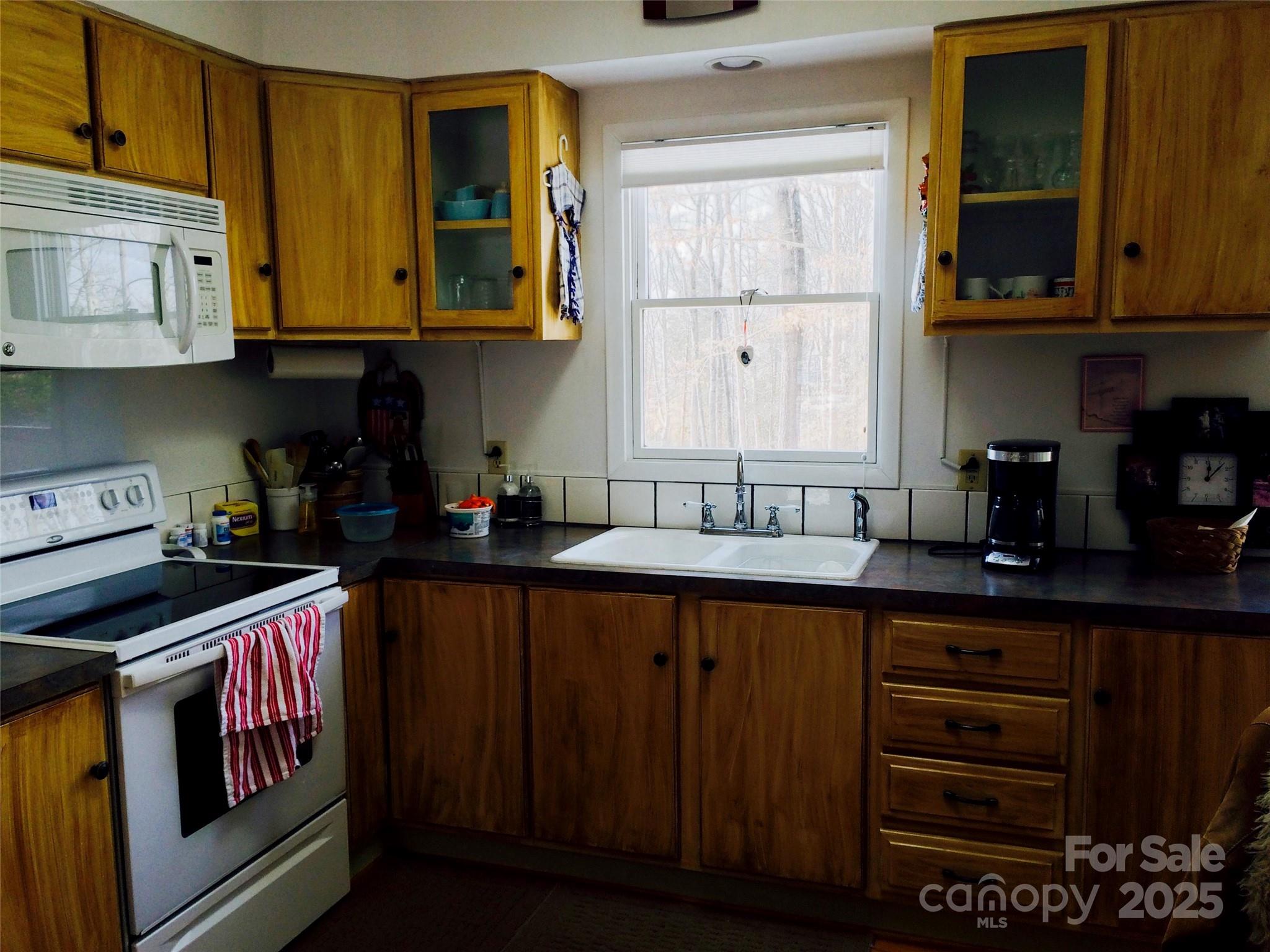 1270 Lilly Drive Clover, SC 29710 - Photo 5 of 8 a kitchen with stainless steel appliances granite countertop a stove and cabinets
