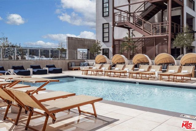 a kitchen area with stainless steel appliances a stove and a microwave