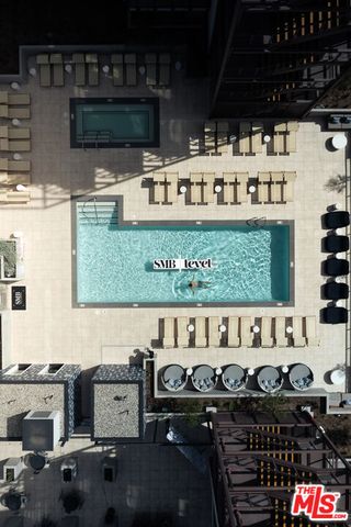 a view of a rooftop deck with couch and a potted plant