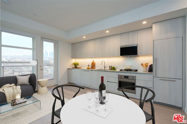 a kitchen with a dining table and chairs