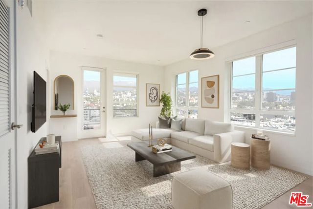 a living room with furniture and a large window