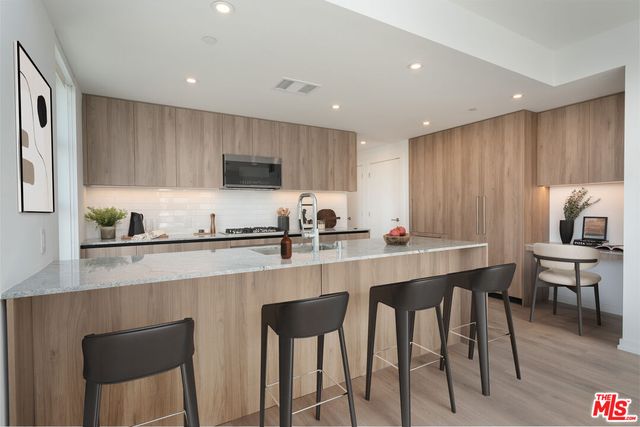a kitchen with a dining table chairs and microwave