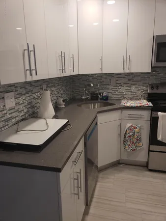 a kitchen with stainless steel appliances granite countertop a sink a stove and a microwave