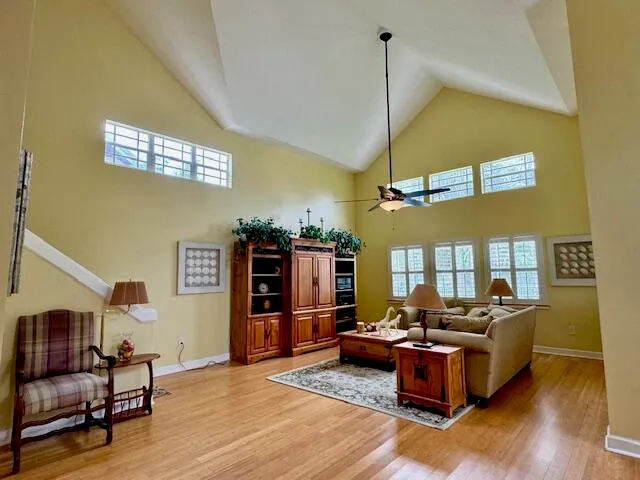 a living room with furniture and wooden floor