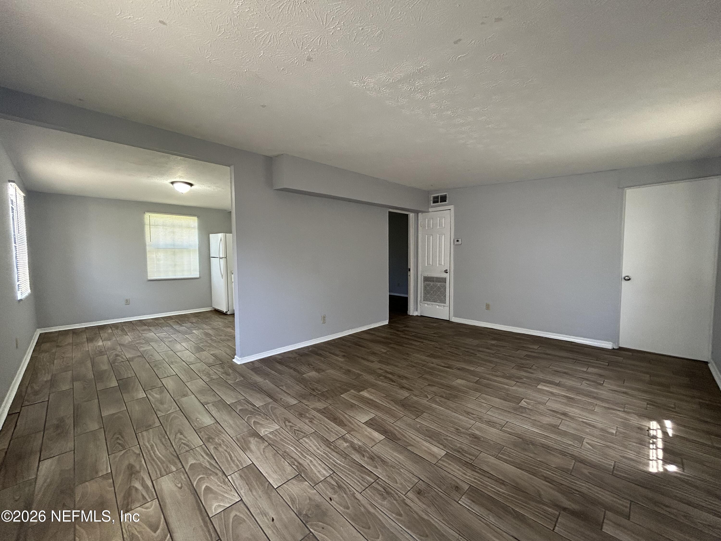 3250 Phyllis Street Jacksonville, FL 32205 - Photo 2 of 9 a view of empty room with wooden floor and fan