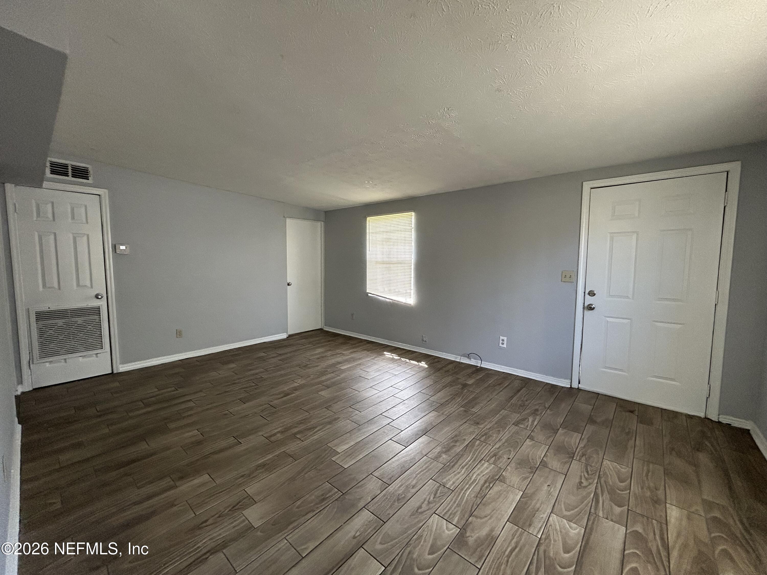 3250 Phyllis Street Jacksonville, FL 32205 - Photo 3 of 9 an empty room with wooden floor and window