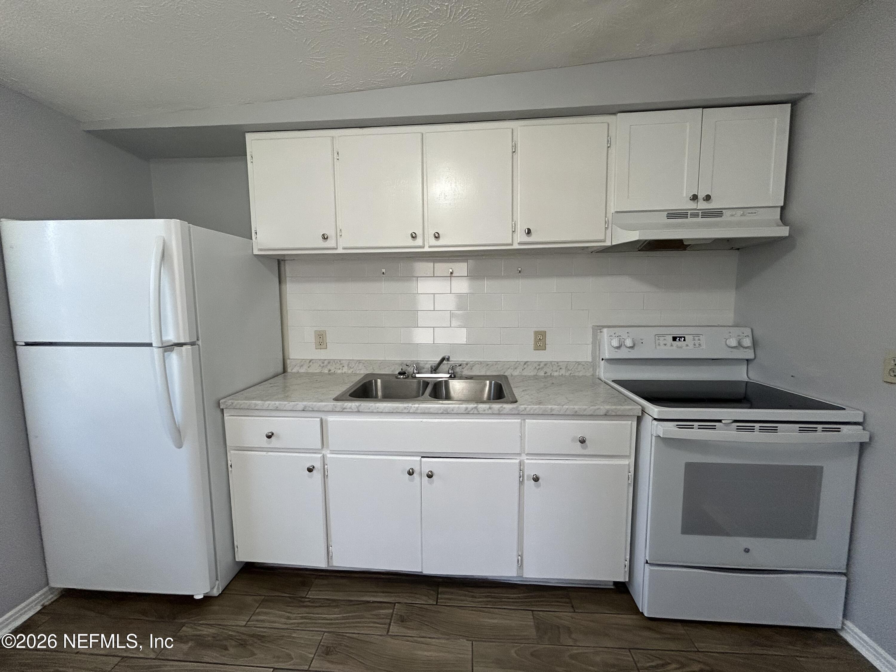 3250 Phyllis Street Jacksonville, FL 32205 - Photo 4 of 9 a kitchen with a sink a stove and refrigerator