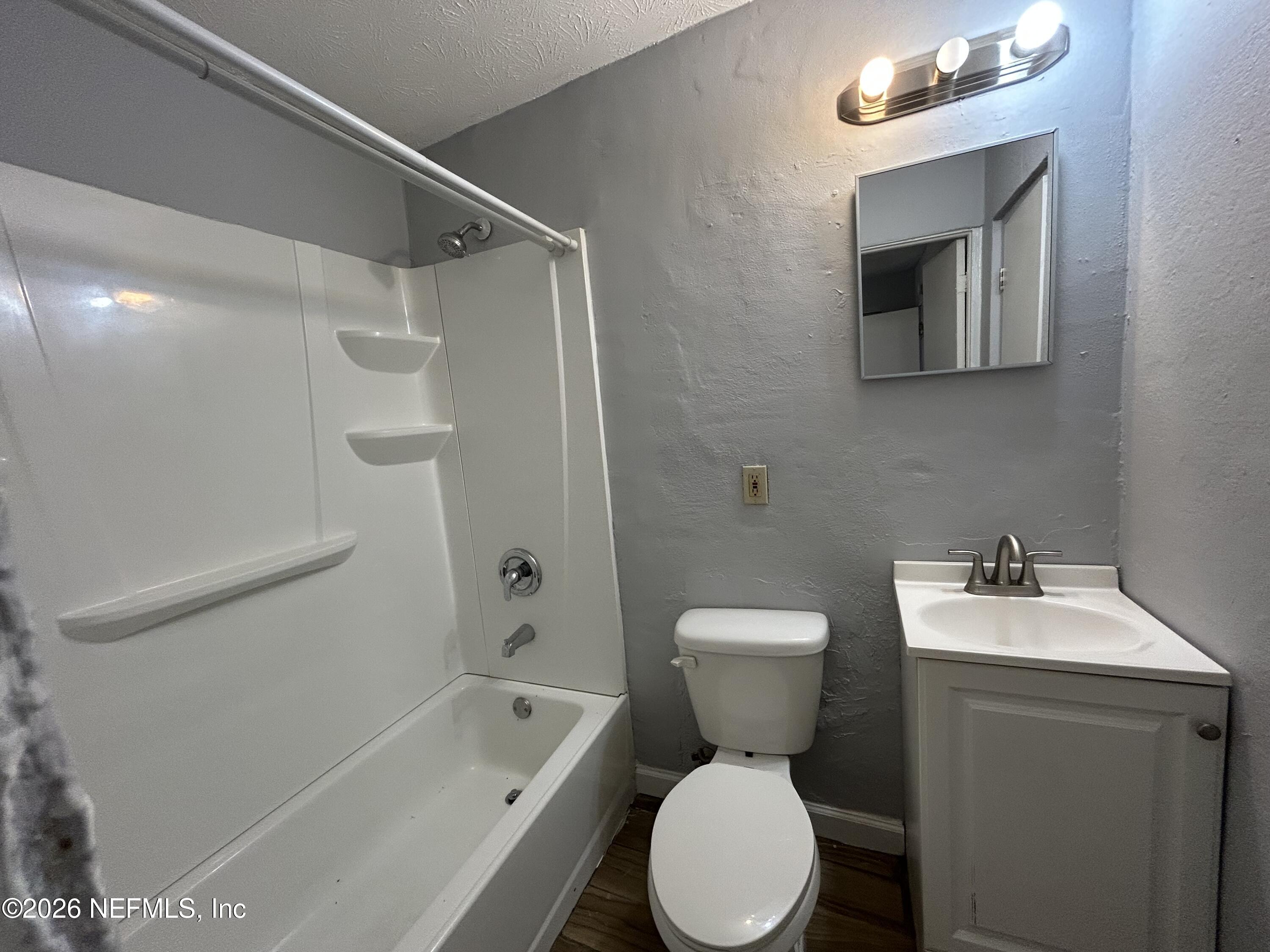 3250 Phyllis Street Jacksonville, FL 32205 - Photo 9 of 9 a white toilet sitting next to a bath tub