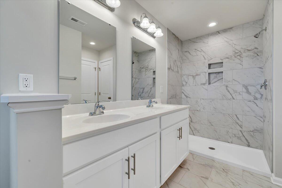 3711 Crescent Ridge Drive Southwest Roanoke, VA 24015 - Photo 13 of 23 a bathroom with a double vanity sink mirror and shower
