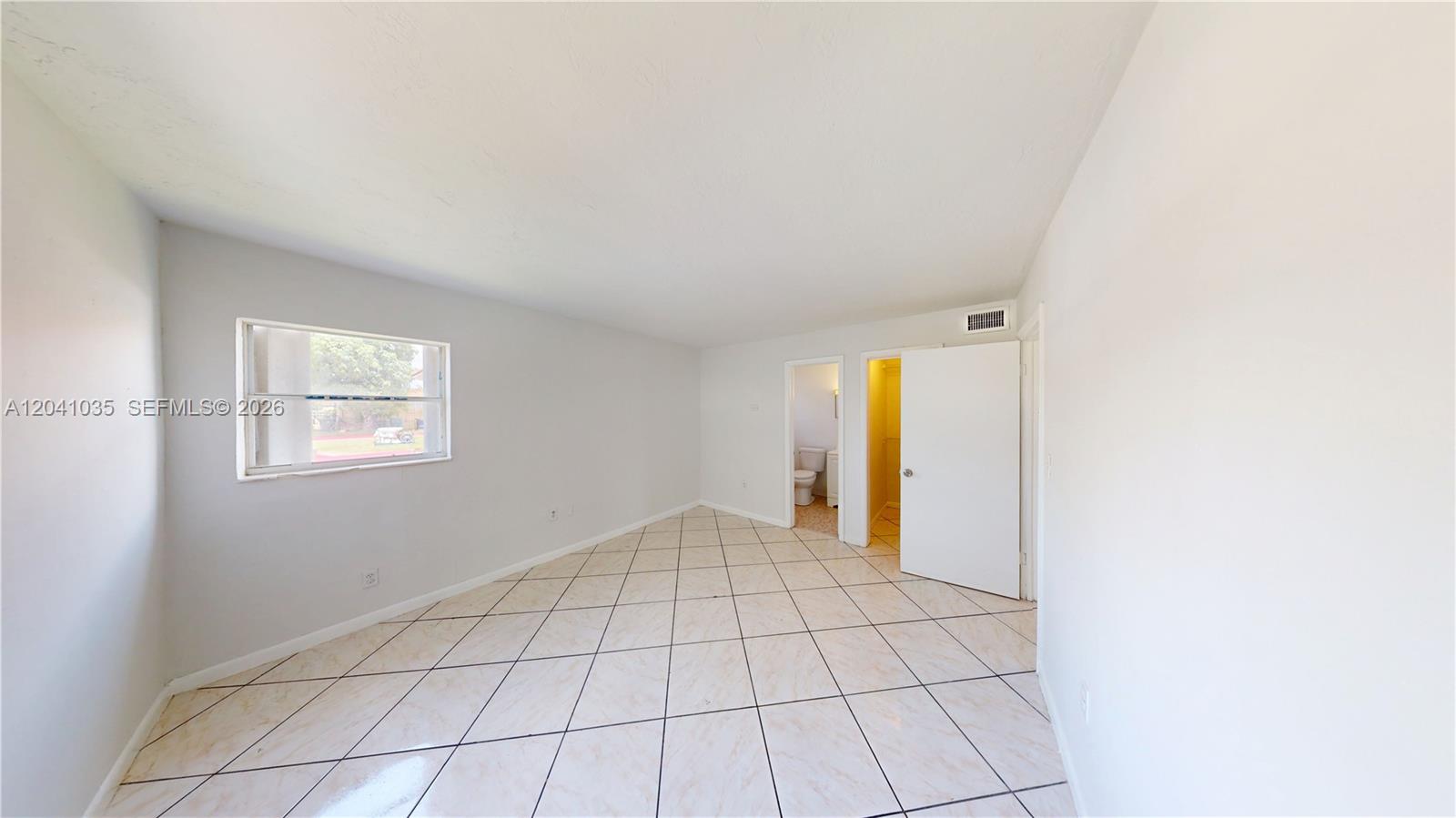 6811 Southwest 16th Street Miami, FL 33144 - Photo 9 of 21 a view of an empty room with a window