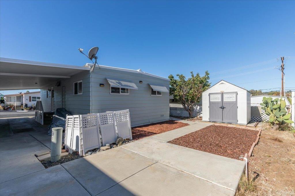 718 Sycamore Avenue, Unit 44 Vista, CA 92083 - Photo 24 of 24 a spacious bedroom with a large bed and a potted plant