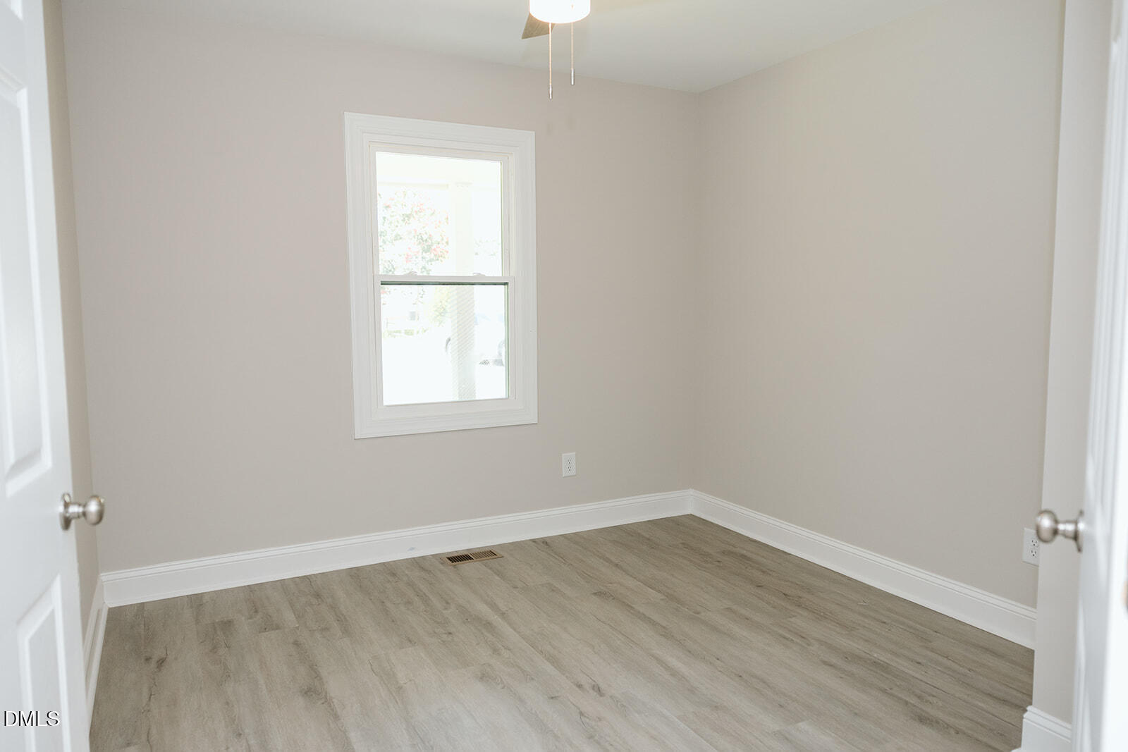 291 Knight Road Broadway, NC 27505 - Photo 11 of 18 an empty room with wooden floor cabinet and windows