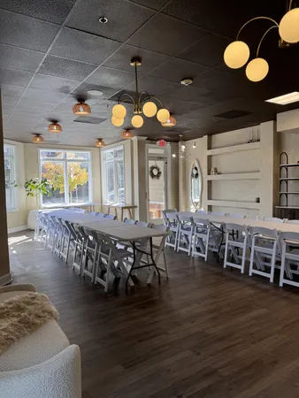 a large room with lots of furniture and chandelier