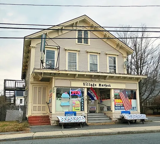 a view of a brick house with large windows