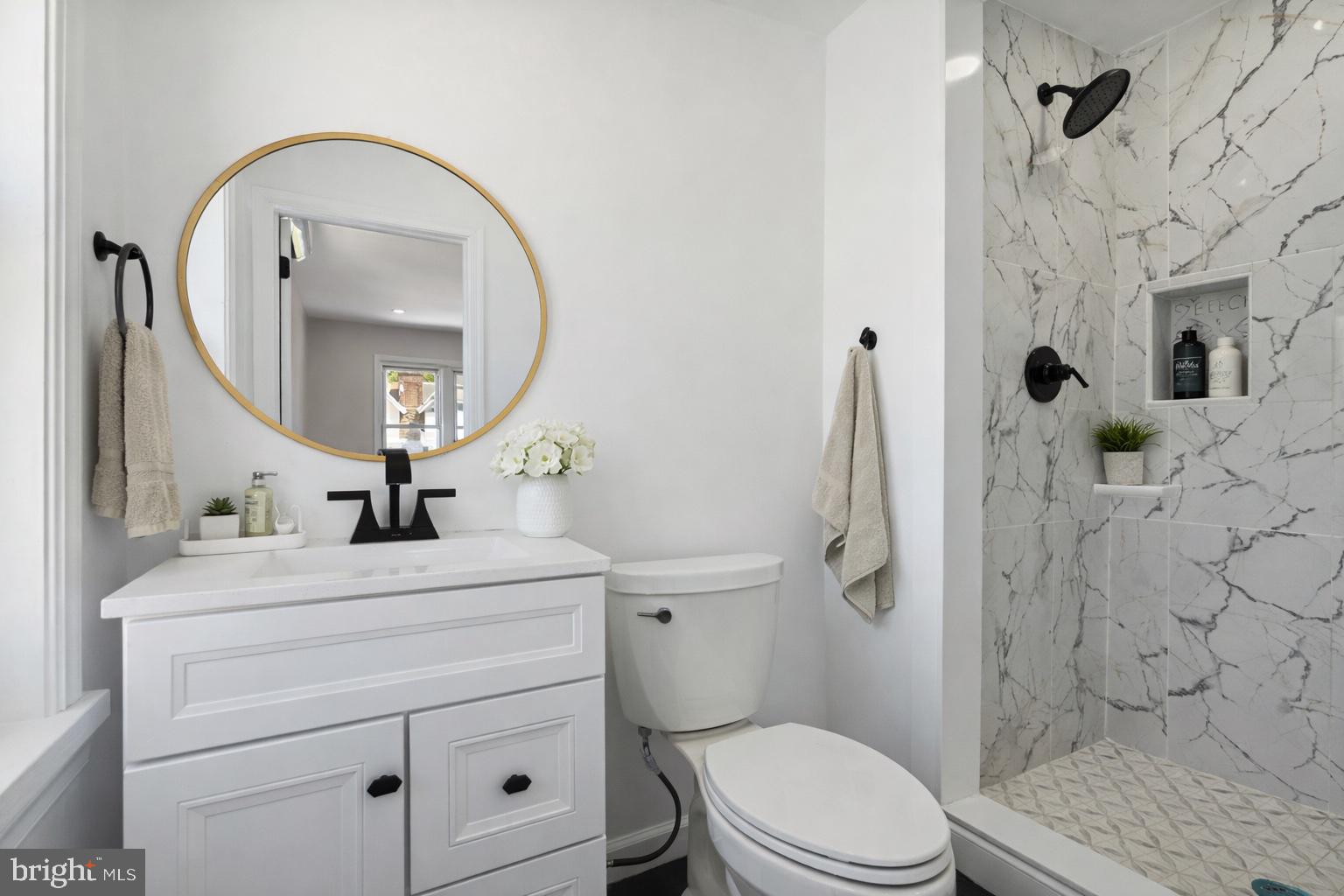 2414 77th Avenue Philadelphia, PA 19150 - Photo 13 of 25 a bathroom with a sink a toilet and a mirror