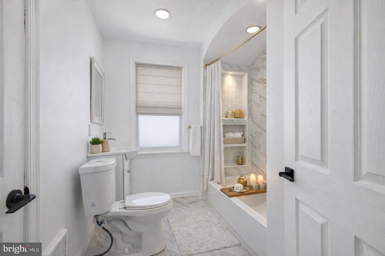 2414 77th Avenue Philadelphia, PA 19150 - Photo 16 of 25 a bathroom with a toilet and shower