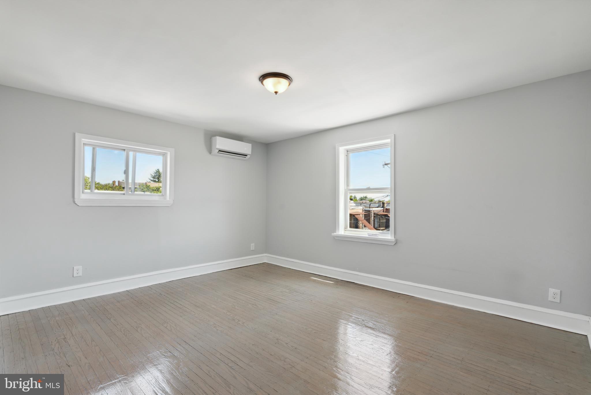 2414 77th Avenue Philadelphia, PA 19150 - Photo 18 of 25 a view of an empty room with a window and wooden floor
