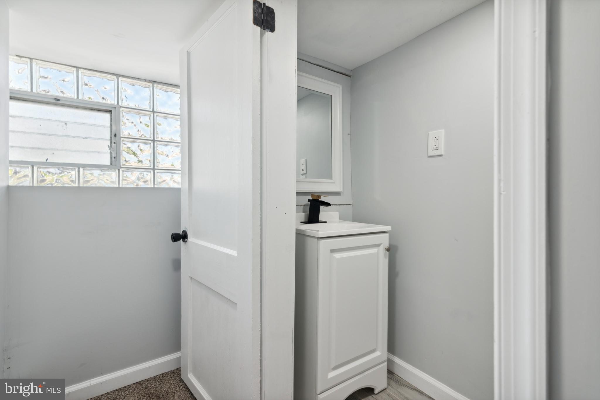 2414 77th Avenue Philadelphia, PA 19150 - Photo 21 of 25 a bathroom with a sink and a window