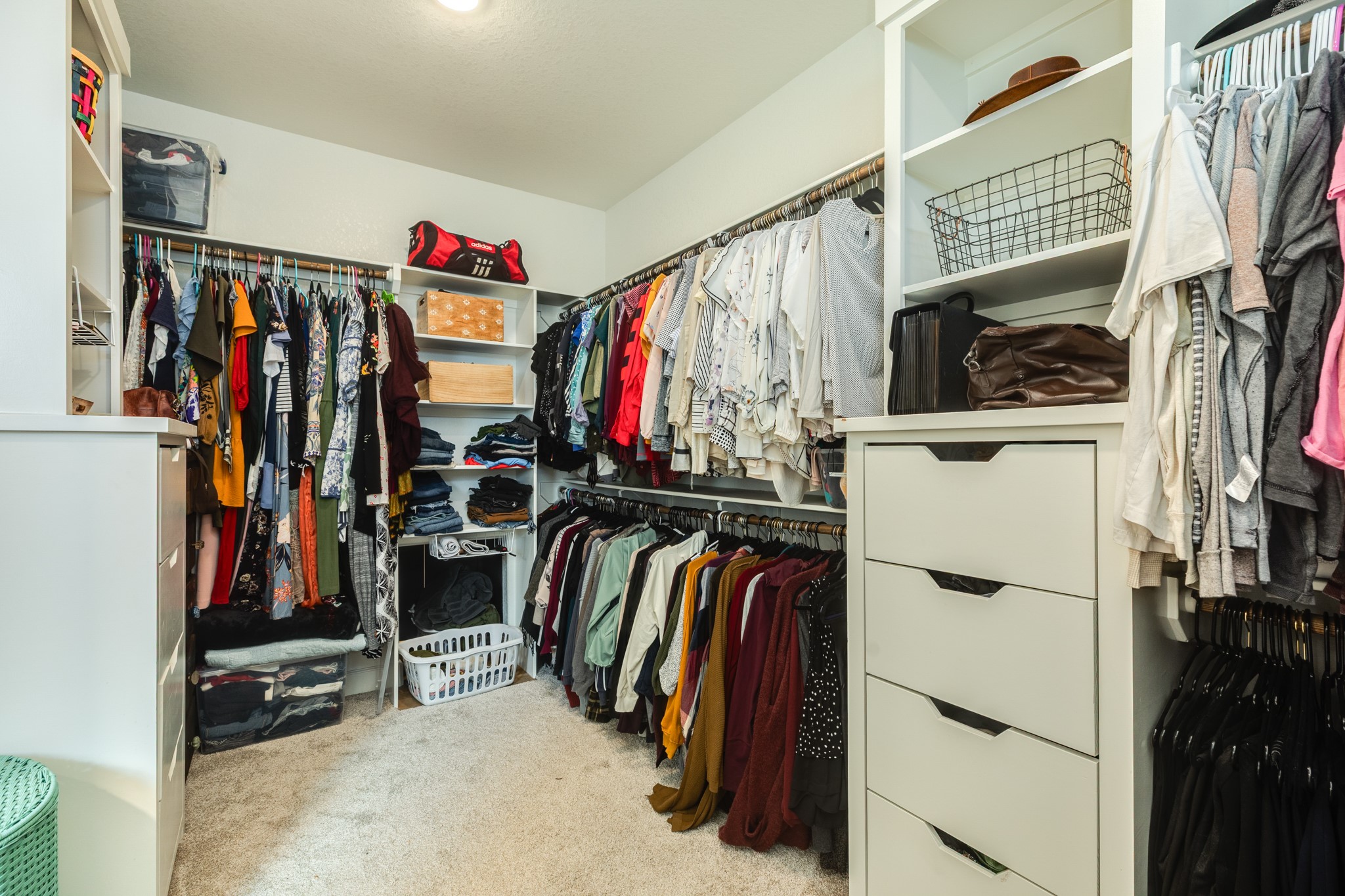 2 Greystone Court Angleton, TX 77515 - Photo 26 of 34 a view of walk in closet with clothes and shoes