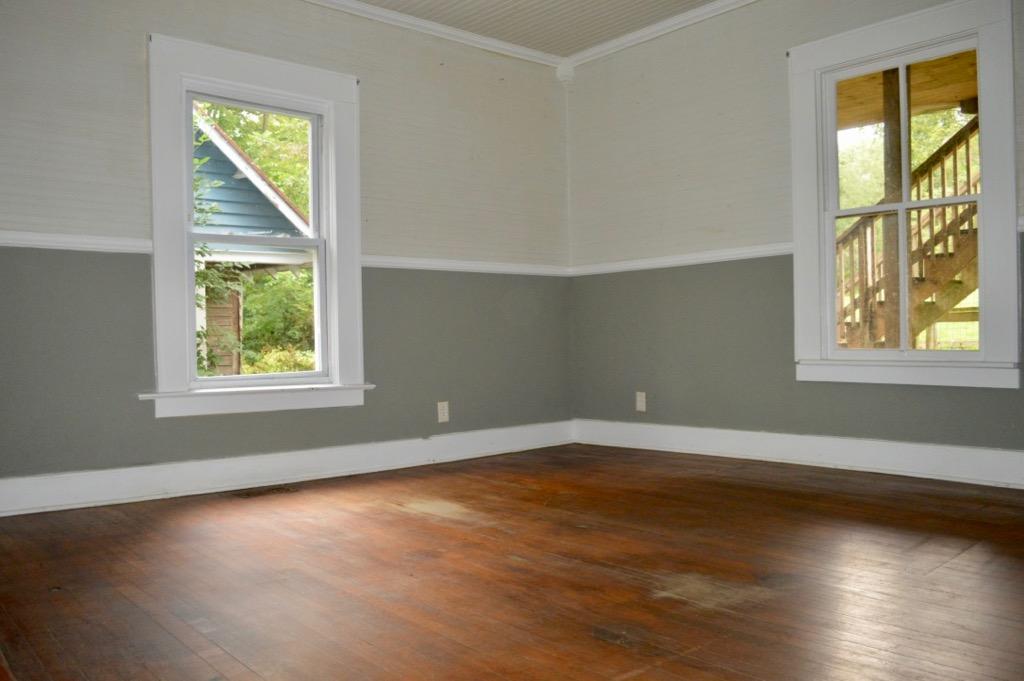 292 Moore Road Northeast Floyd, VA 24091 - Photo 8 of 65 an empty room with wooden floor and windows