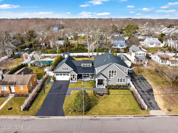 an aerial view of residential houses with yard