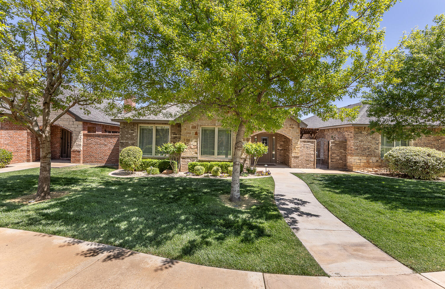 4402 108th Street, Unit 10 Lubbock, TX 79424 - Photo 1 of 21 a front view of a house with a yard and porch