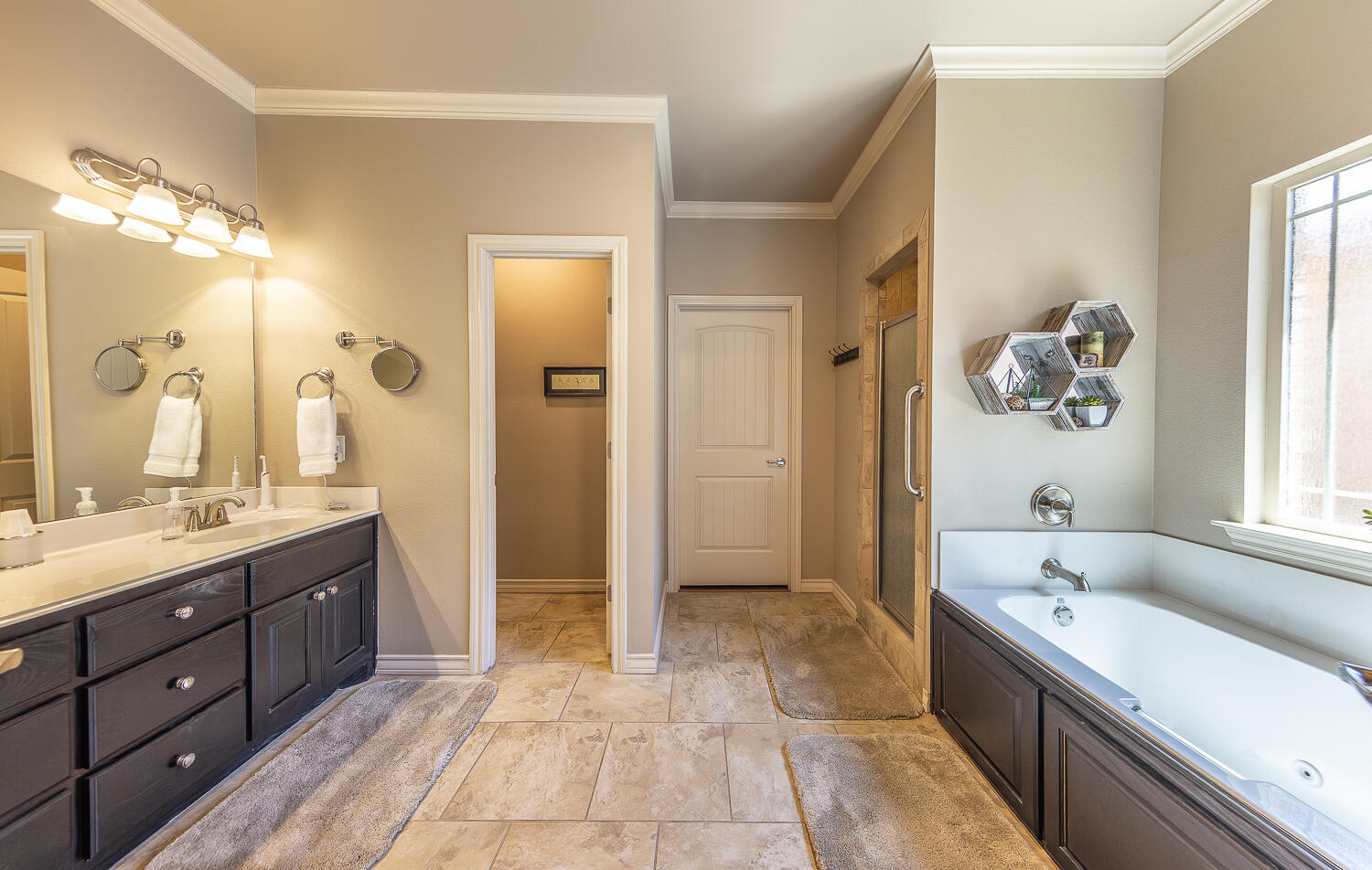 4402 108th Street, Unit 10 Lubbock, TX 79424 - Photo 11 of 21 a spacious bathroom with a tub sink and mirror