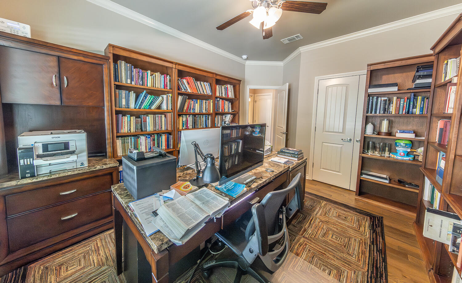 4402 108th Street, Unit 10 Lubbock, TX 79424 - Photo 14 of 21 a workspace with furniture and book shelf