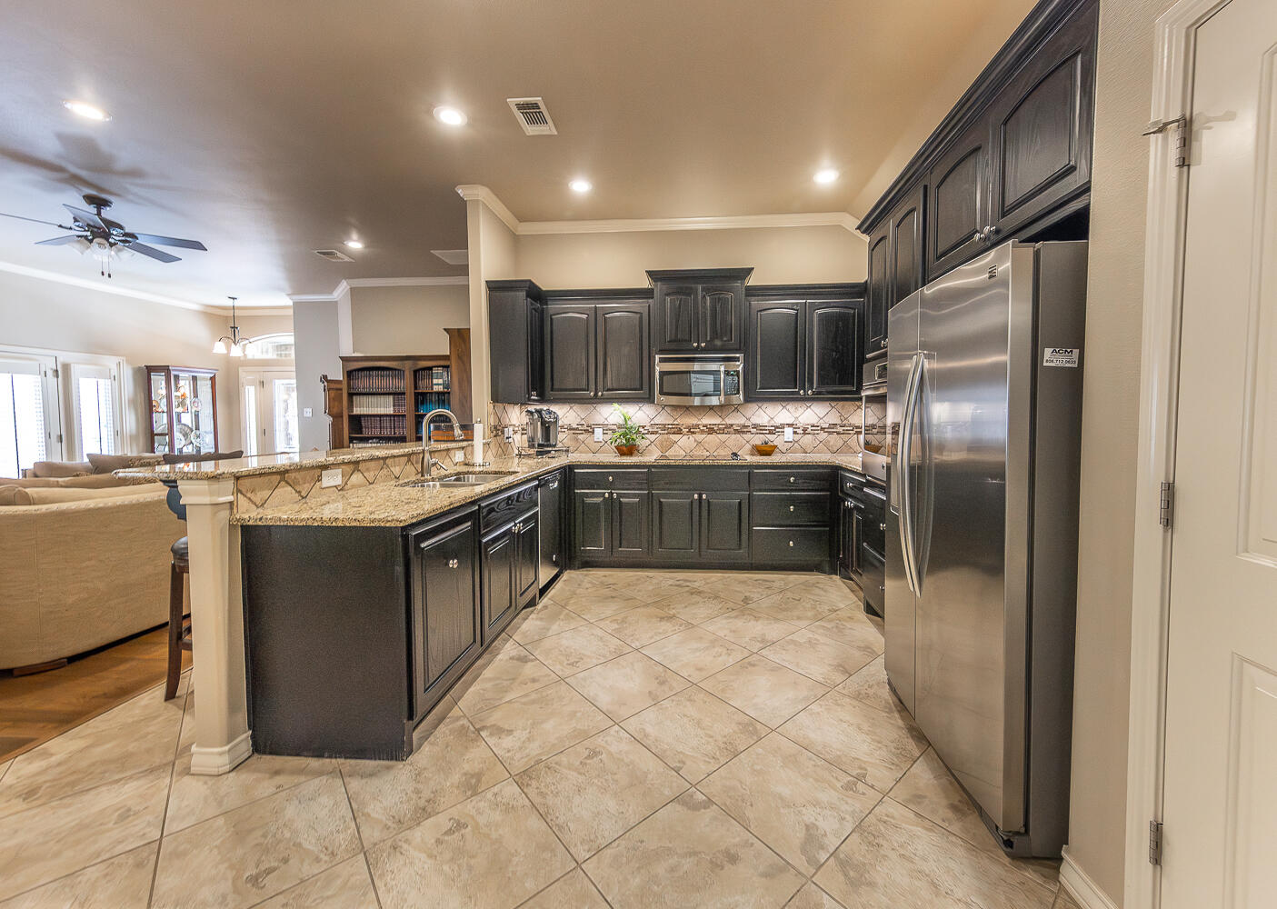 4402 108th Street, Unit 10 Lubbock, TX 79424 - Photo 3 of 21 a large kitchen with stainless steel appliances lots of counter top space