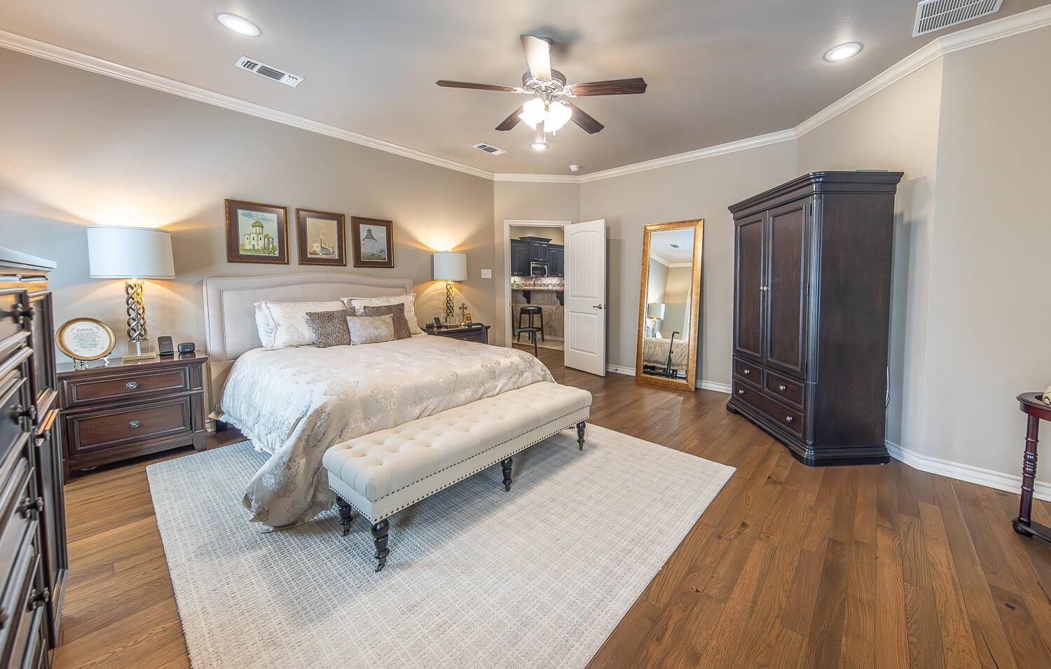 4402 108th Street, Unit 10 Lubbock, TX 79424 - Photo 10 of 21 a spacious bedroom with a bed a dresser and a chandelier