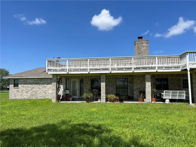 a view of a house with a backyard porch and sitting area