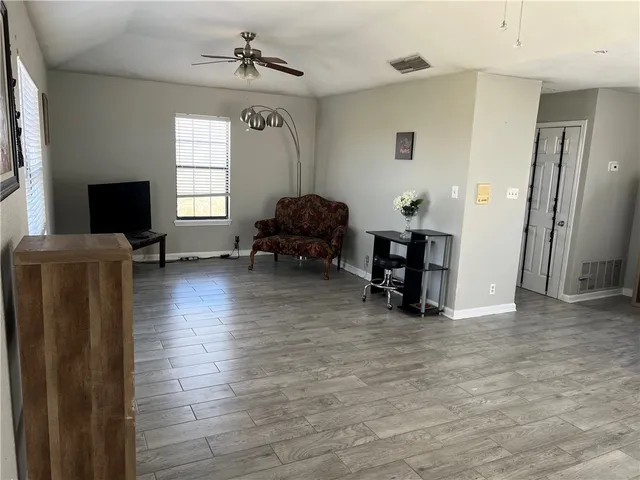 a living room with furniture window and wooden floor