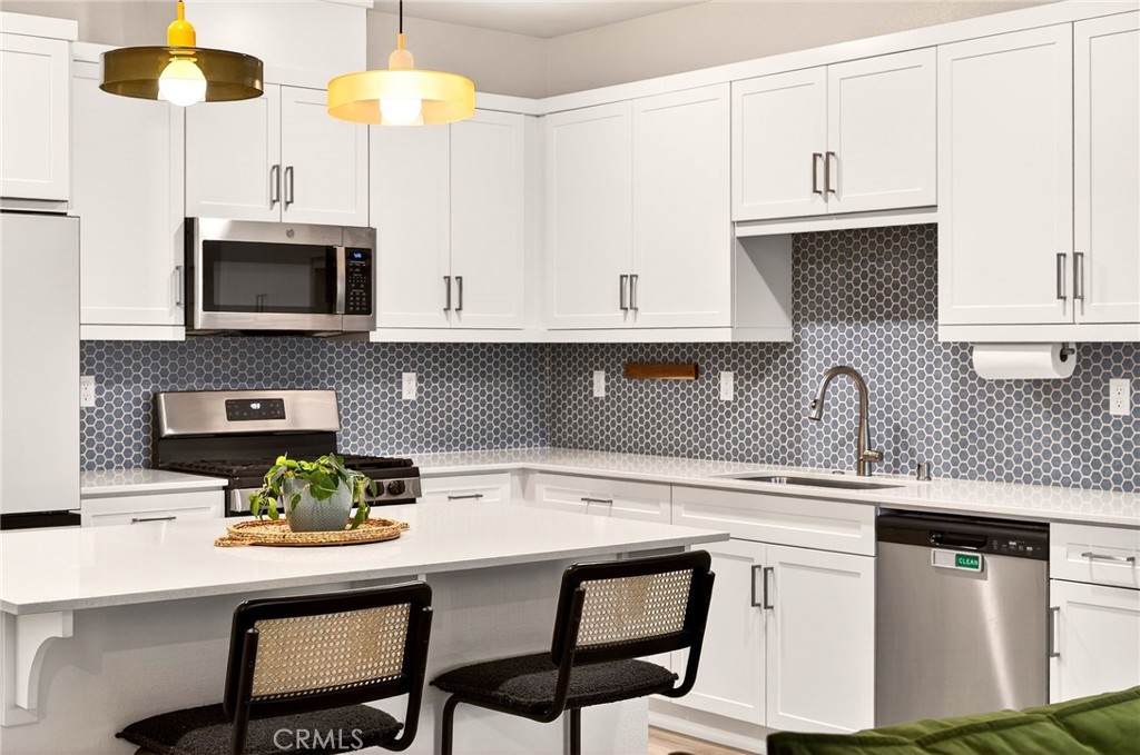 35165 Rangpur Lane Fallbrook, CA 92028 - Photo 1 of 42 a kitchen with stainless steel appliances kitchen island granite countertop a sink a microwave and cabinets