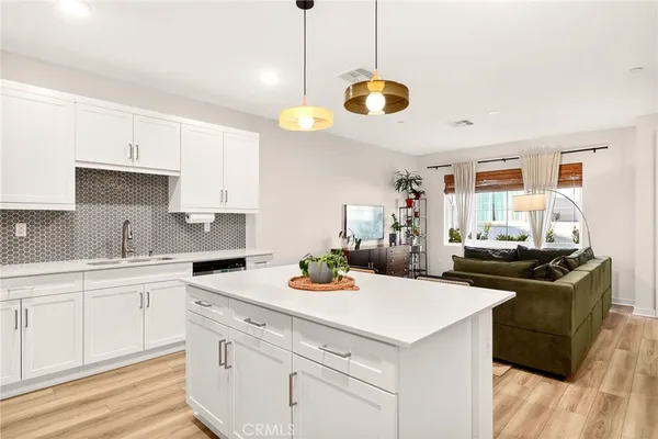 a kitchen with a stove a sink and cabinets