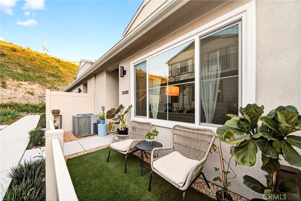 35165 Rangpur Lane Fallbrook, CA 92028 - Photo 2 of 42 a view of a patio with table and chairs potted plants and floor to ceiling window