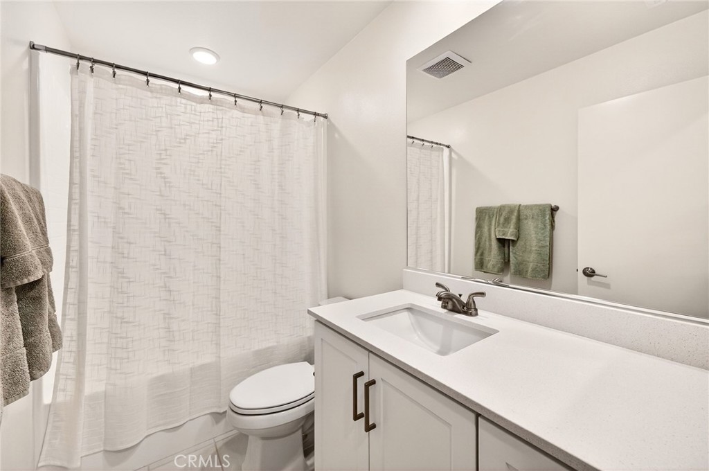 35165 Rangpur Lane Fallbrook, CA 92028 - Photo 22 of 42 a bathroom with a sink a toilet and shower curtain
