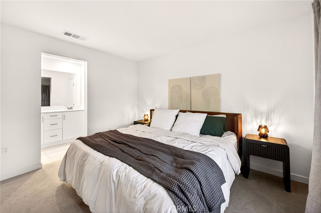 35165 Rangpur Lane Fallbrook, CA 92028 - Photo 28 of 42 a bedroom with a bed and a lamp