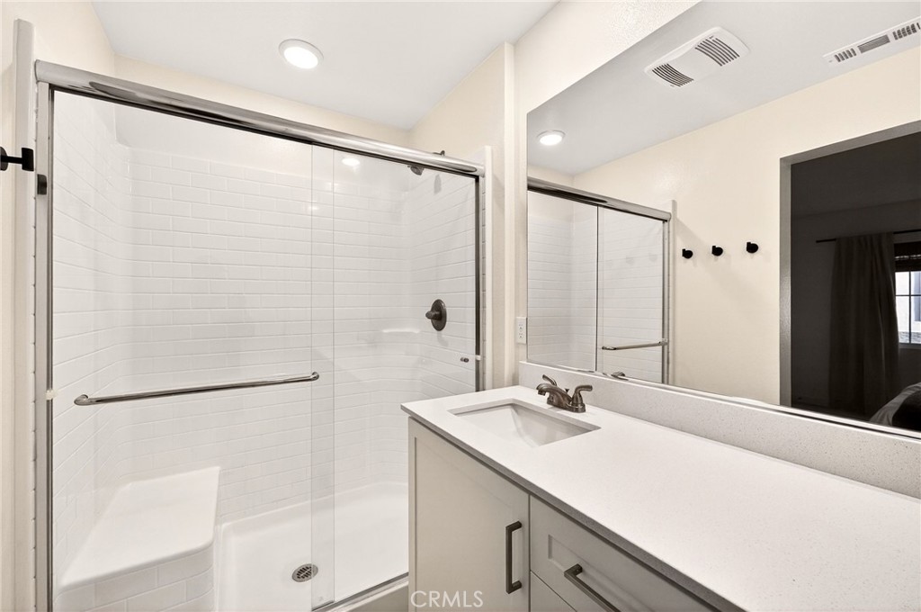 35165 Rangpur Lane Fallbrook, CA 92028 - Photo 31 of 42 a bathroom with a double vanity sink and mirror
