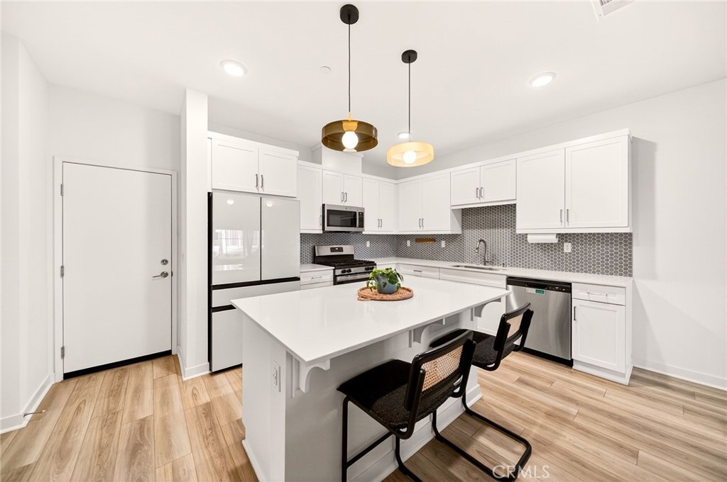 35165 Rangpur Lane Fallbrook, CA 92028 - Photo 9 of 42 a kitchen with a refrigerator a sink and cabinets