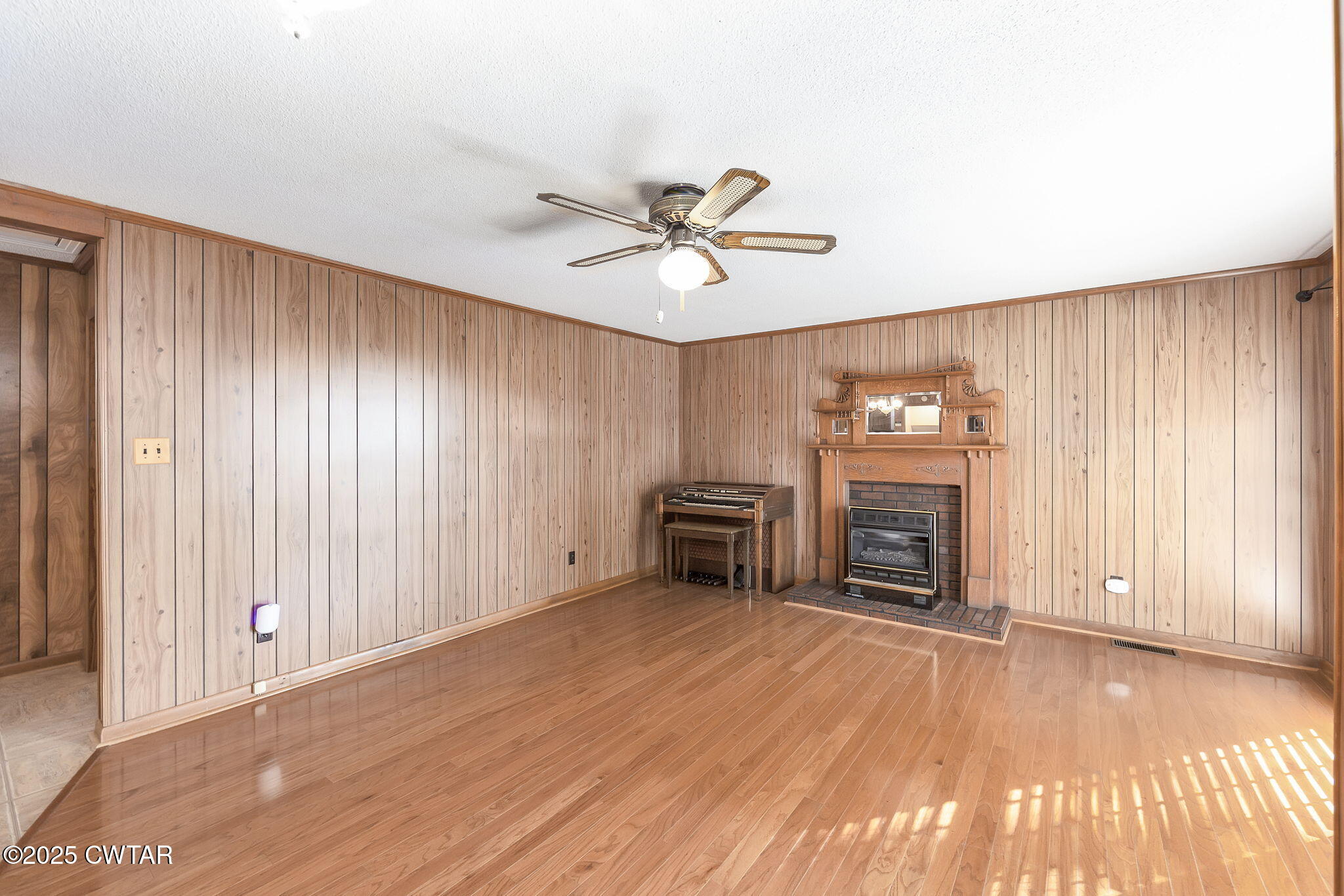 404 Callis Drive Rutherford, TN 38369 - Photo 17 of 39 an empty room with windows fireplace and a ceiling fan