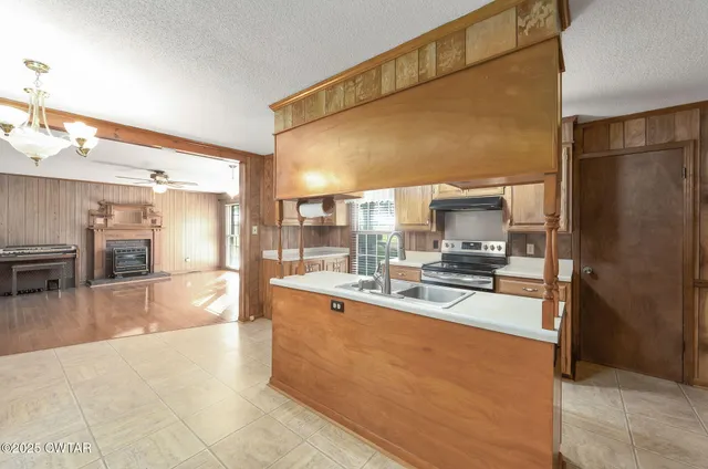 a large white kitchen with a large window