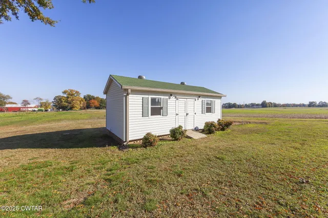 a view of a house with a yard and lake view