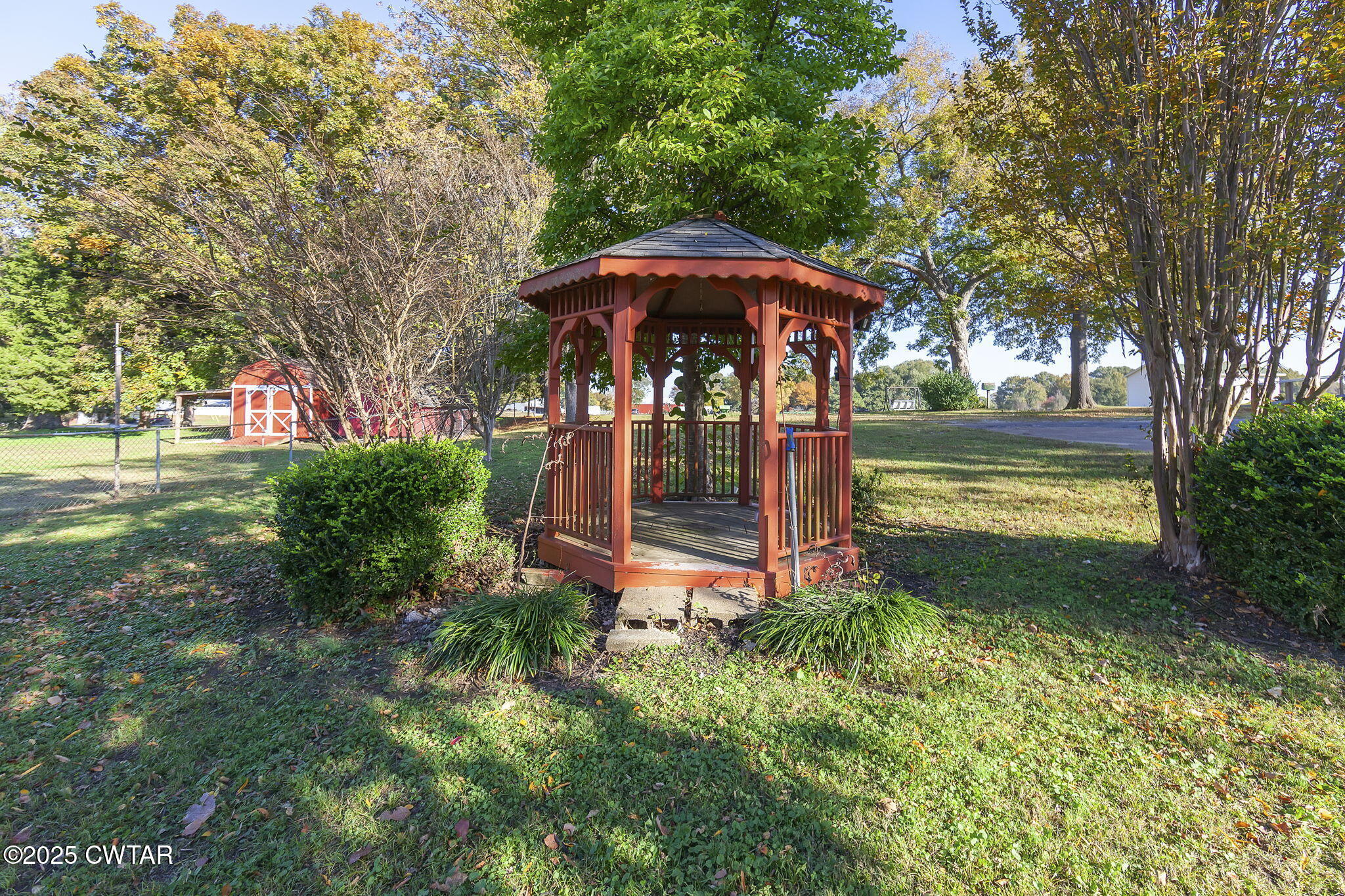 404 Callis Drive Rutherford, TN 38369 - Photo 10 of 39 a view of a small yard in front of a house with a fountain and large trees