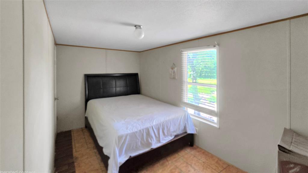 14628 Fm Road Scurry, TX 75158 - Photo 9 of 14 a bedroom with a bed and a window