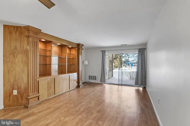 wooden floor in an empty room with a window