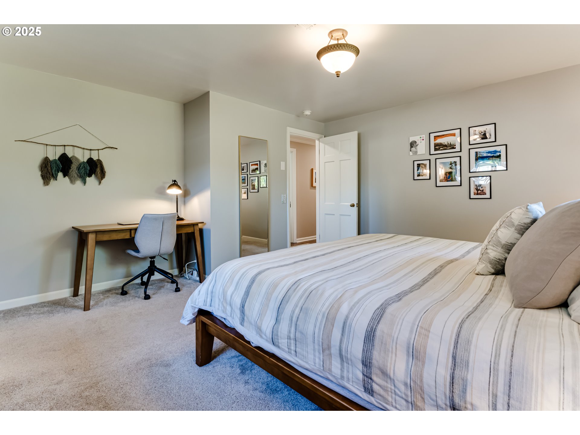 445 Hazel Court Eugene, OR 97401 - Photo 18 of 40 a bedroom with a bed a table and chair