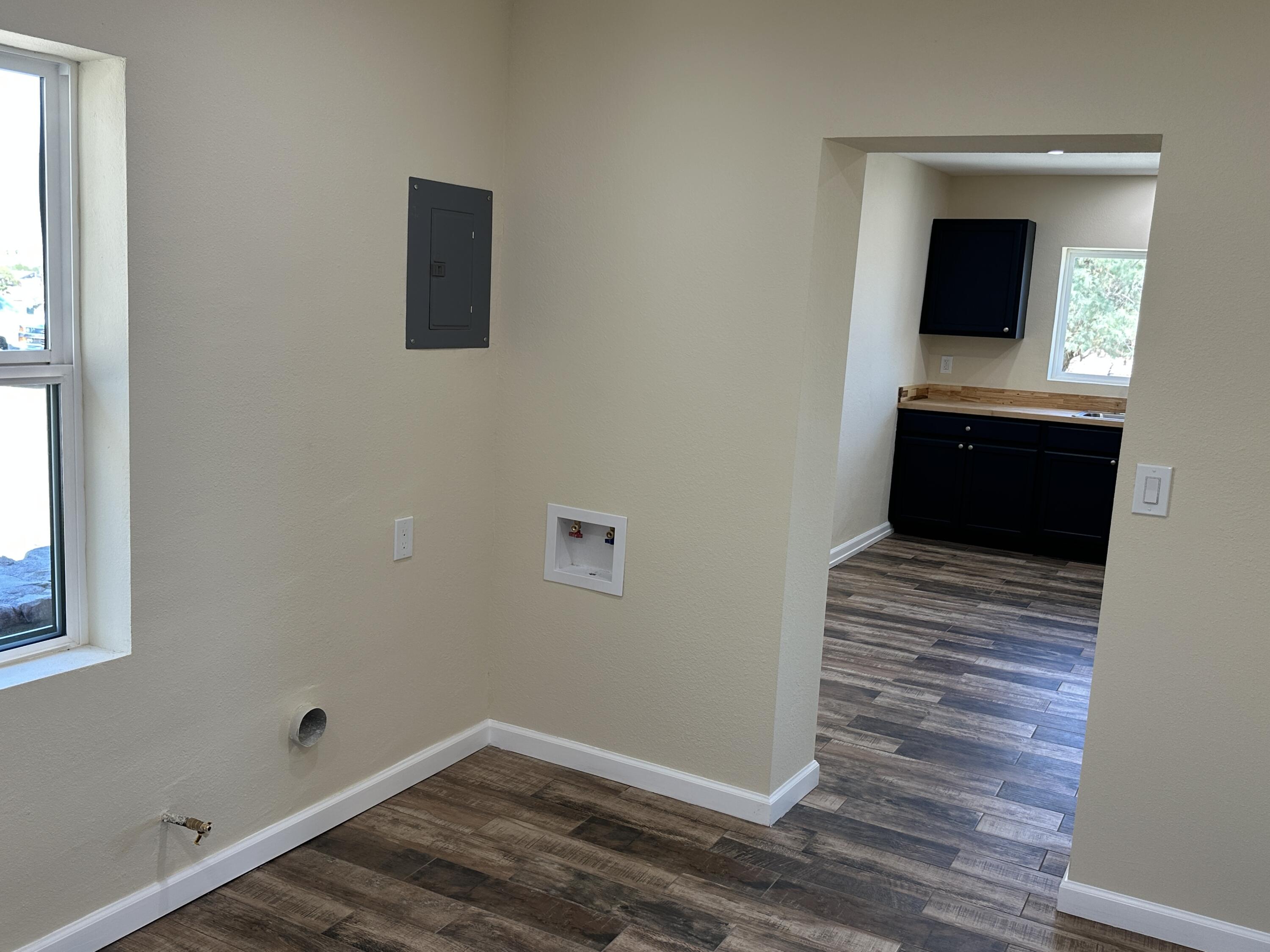 12164 B Street Trona, CA 93562 - Photo 13 of 41 a view of a hallway with wooden floor and a window